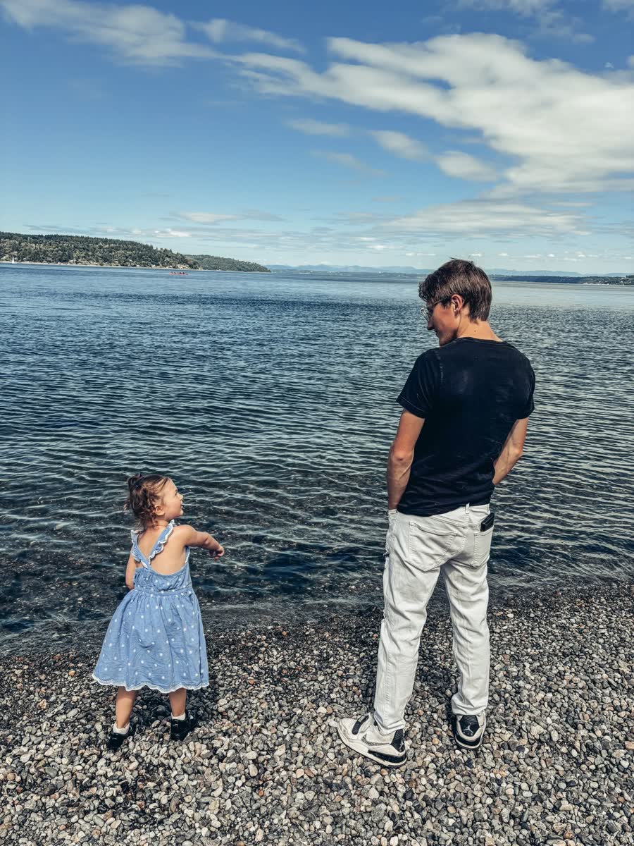 Victor, founder of 1XEV Media, on a Puget Sound beach with his daughter — Pacific Northwest