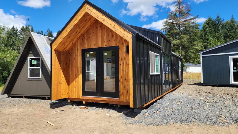 A California Style cabin shell with windows and a full door